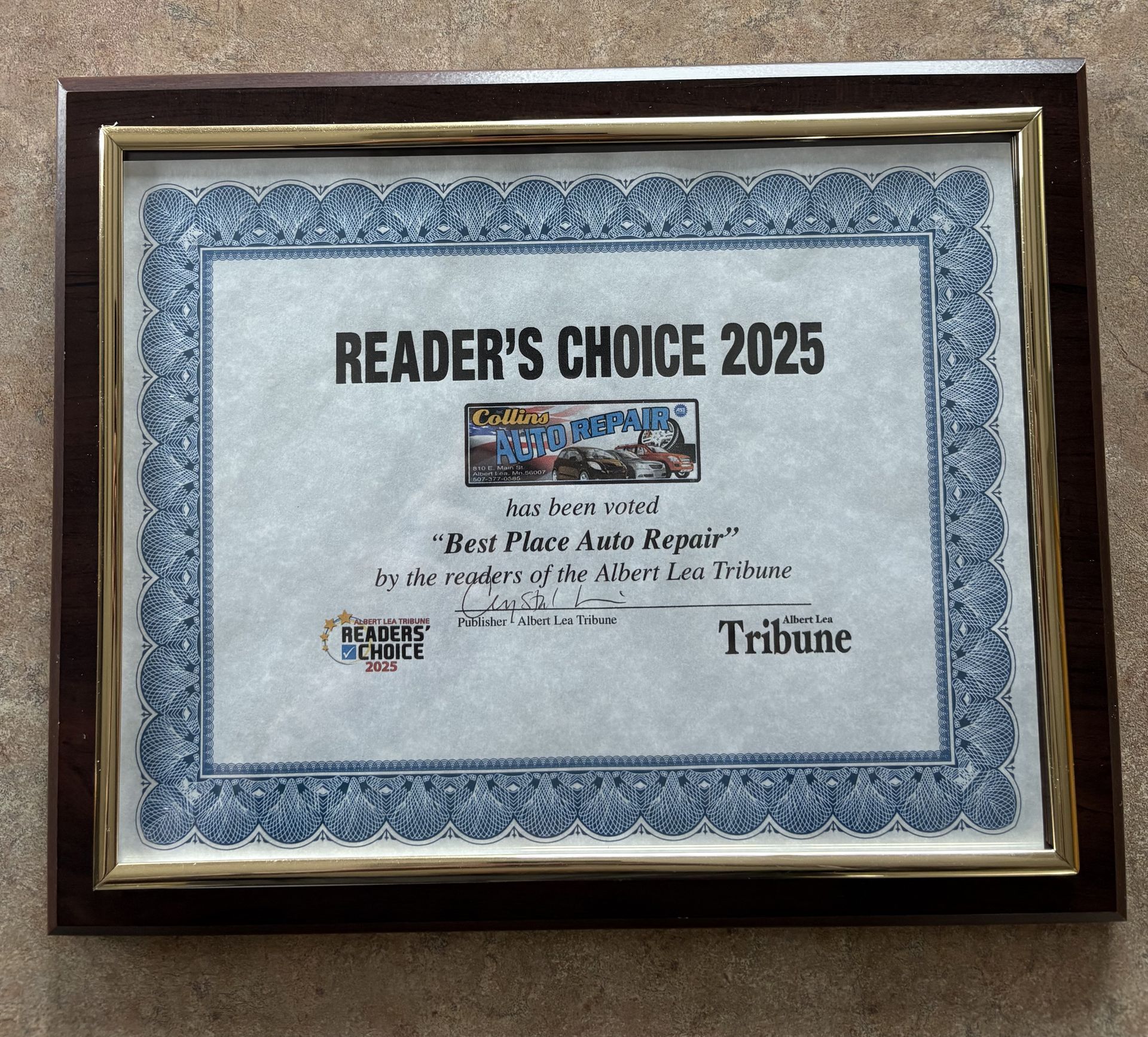 Framed Reader’s Choice 2025 plaque with blue decorative border and Tribune logo