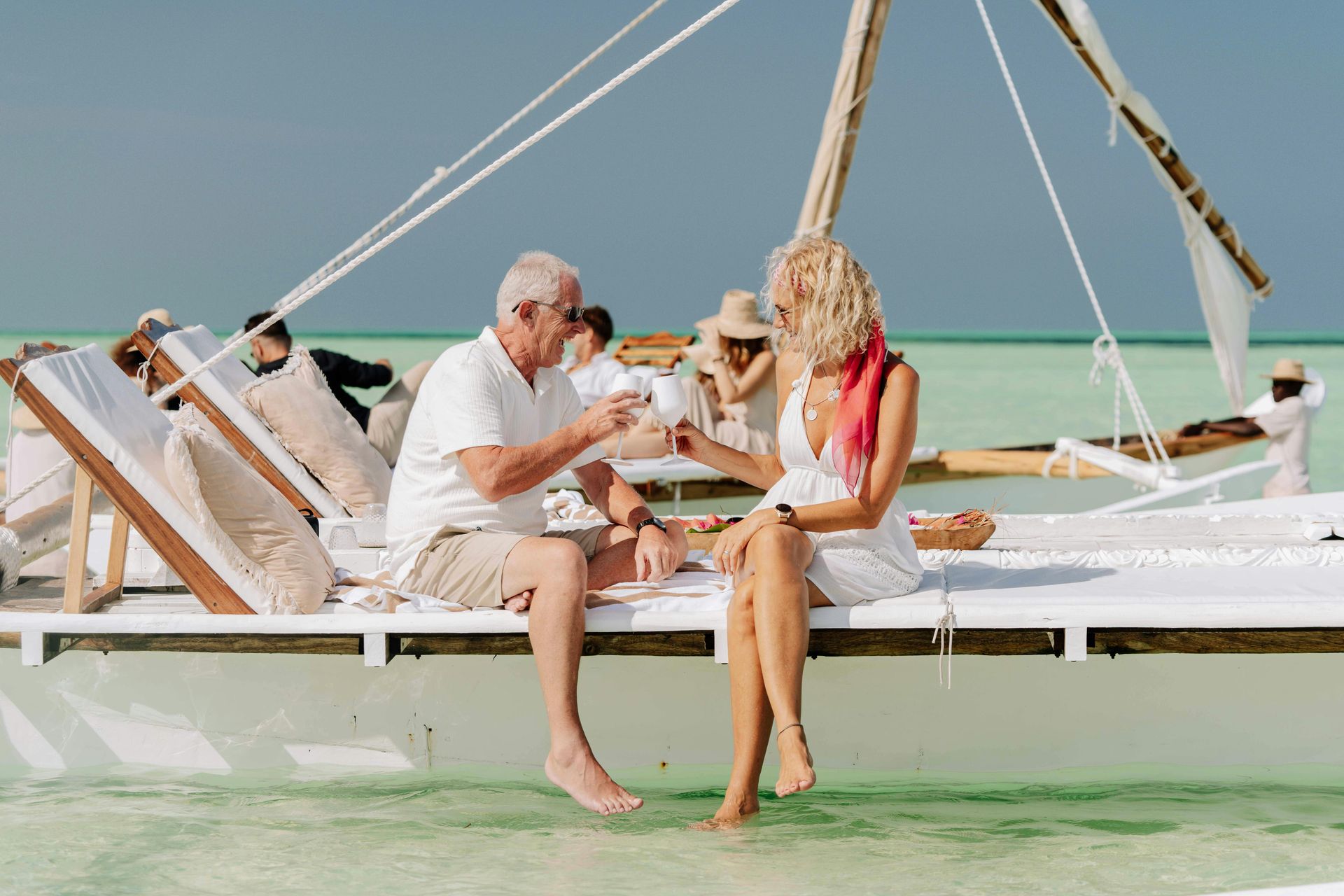 A man and a woman are sitting on a boat in the ocean.