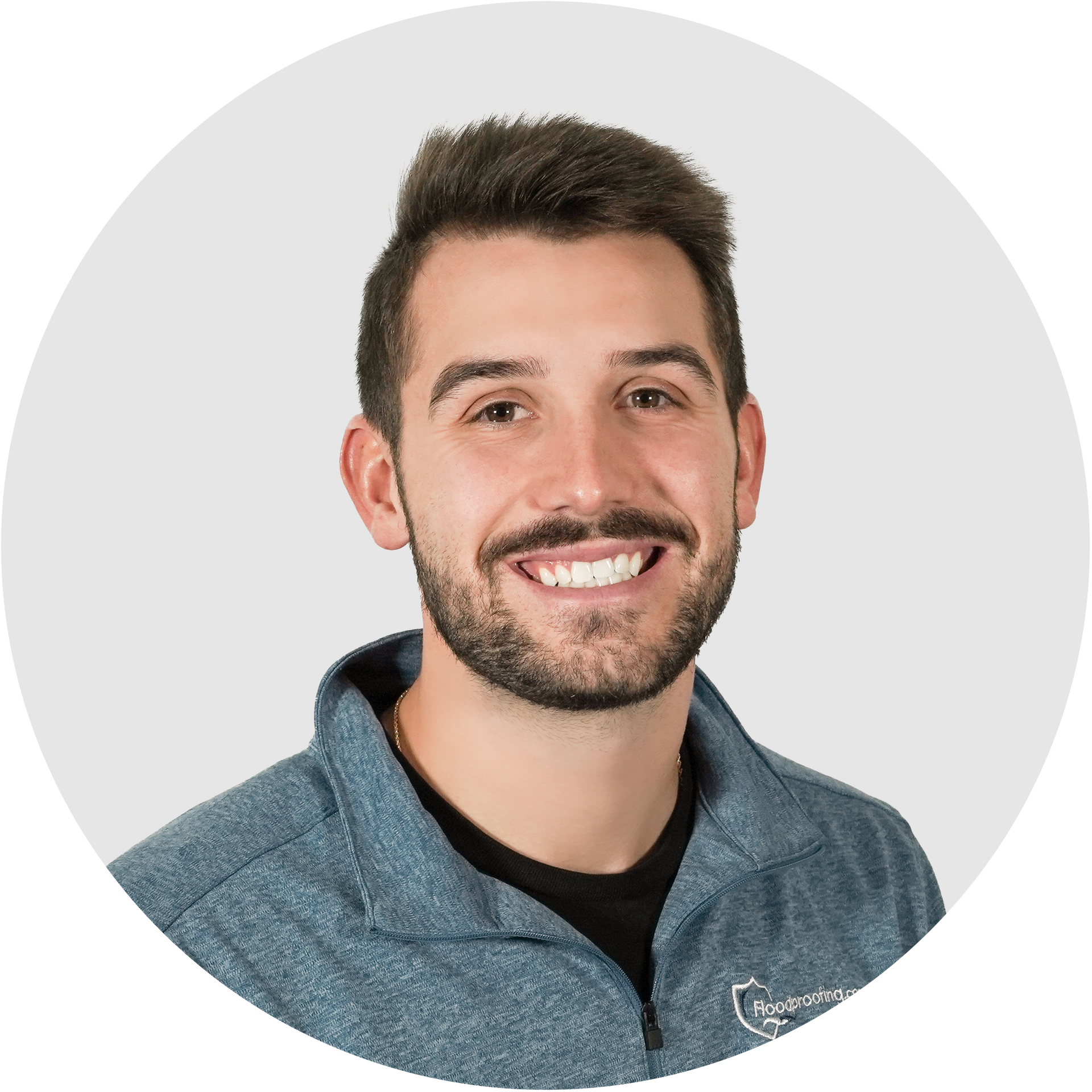 A man with a beard is smiling in a circle.