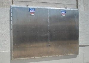 A large stainless steel box is hanging on a wall.