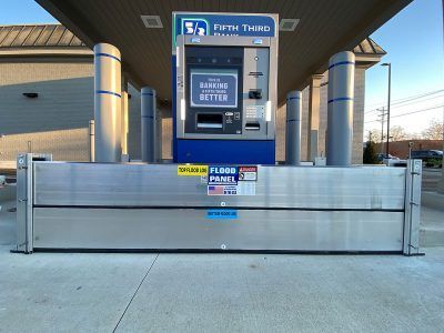 A fifth third gas station has a flood barrier in front of it