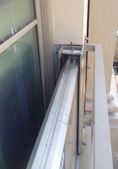 A close up of a window with a metal railing.