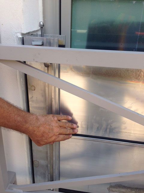 A person is opening a door with their hand.