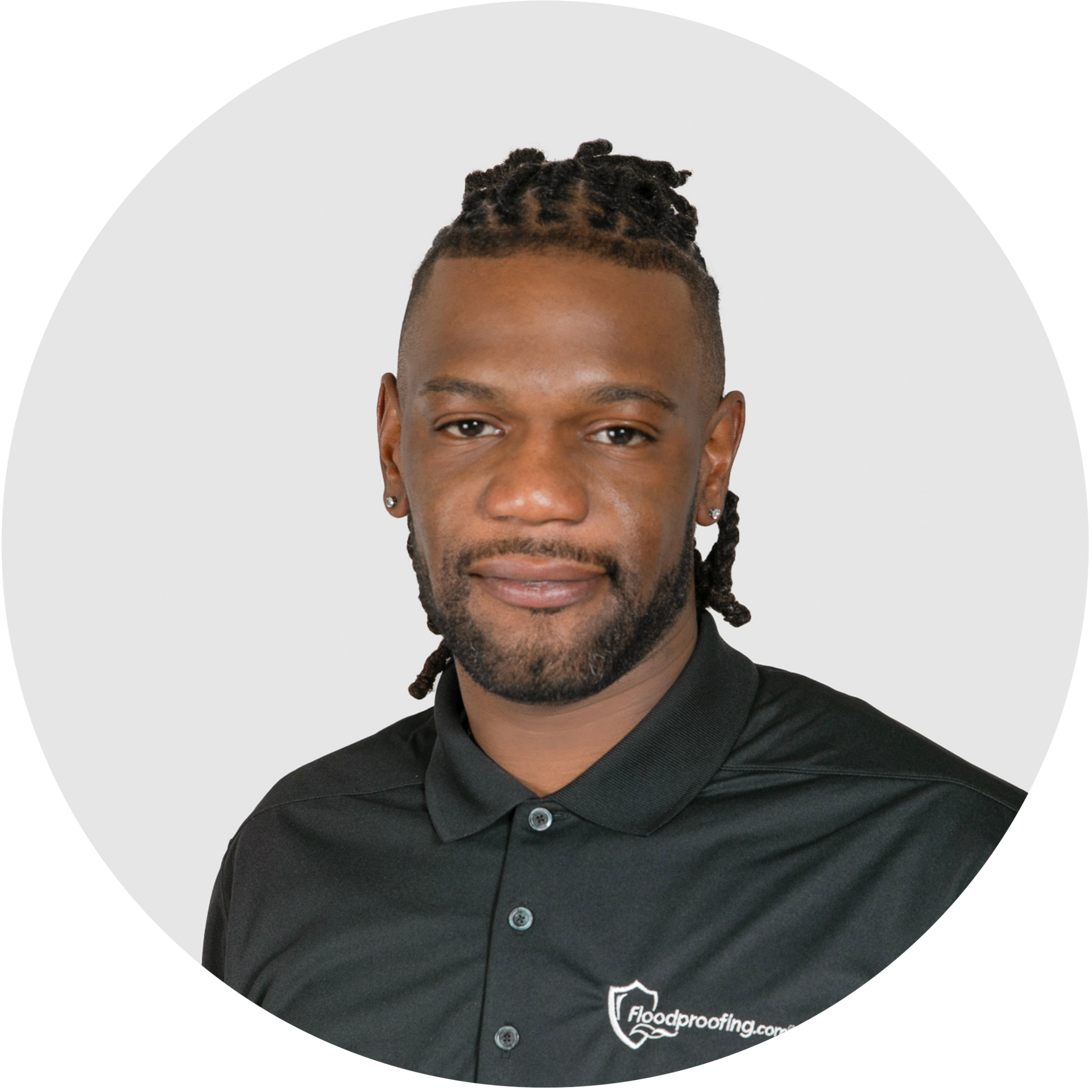 A man with dreadlocks and a beard is smiling in a circle.