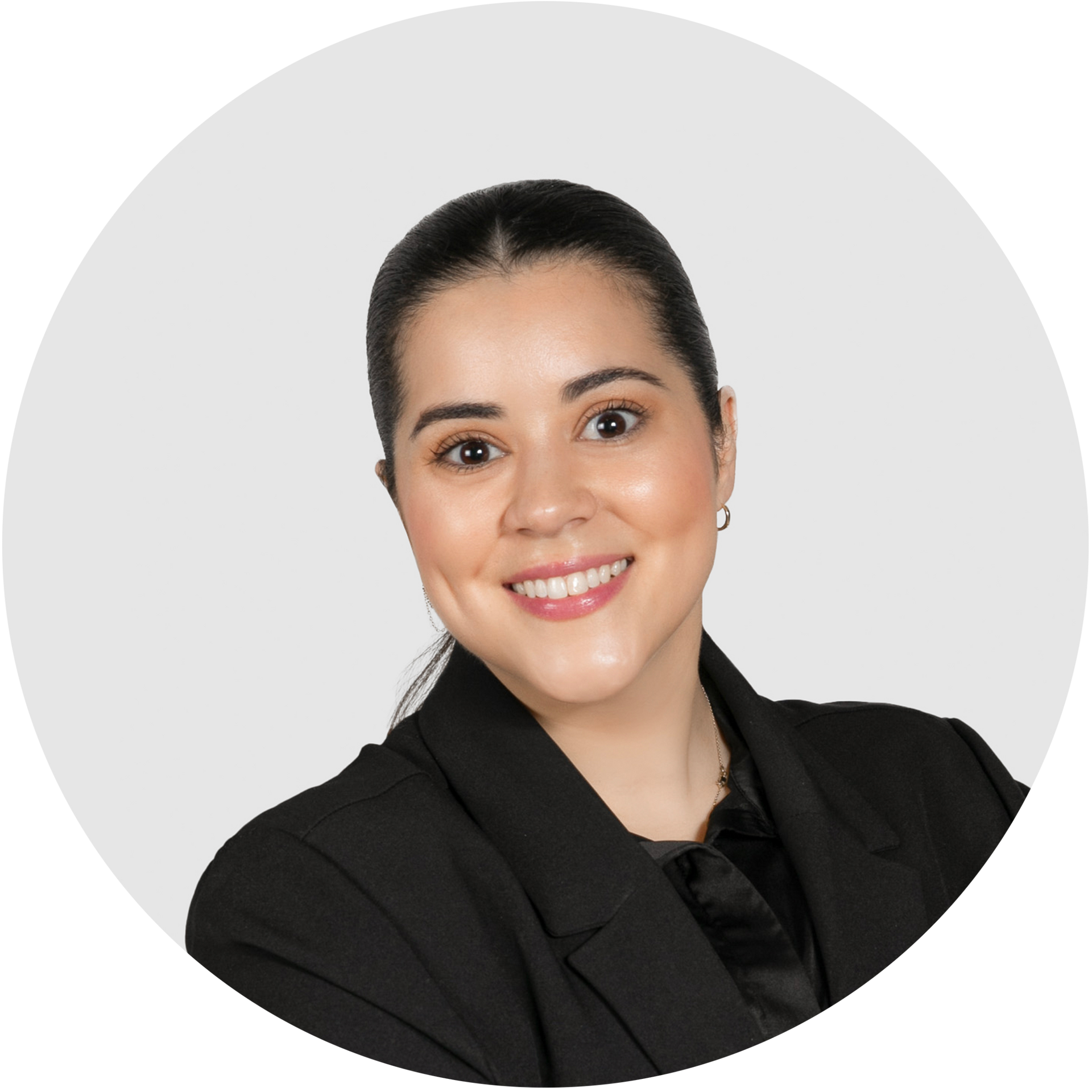 A woman in a plaid jacket and black turtleneck is smiling in a circle.