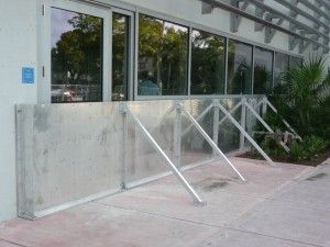 A building with a concrete wall and a metal railing in front of it.