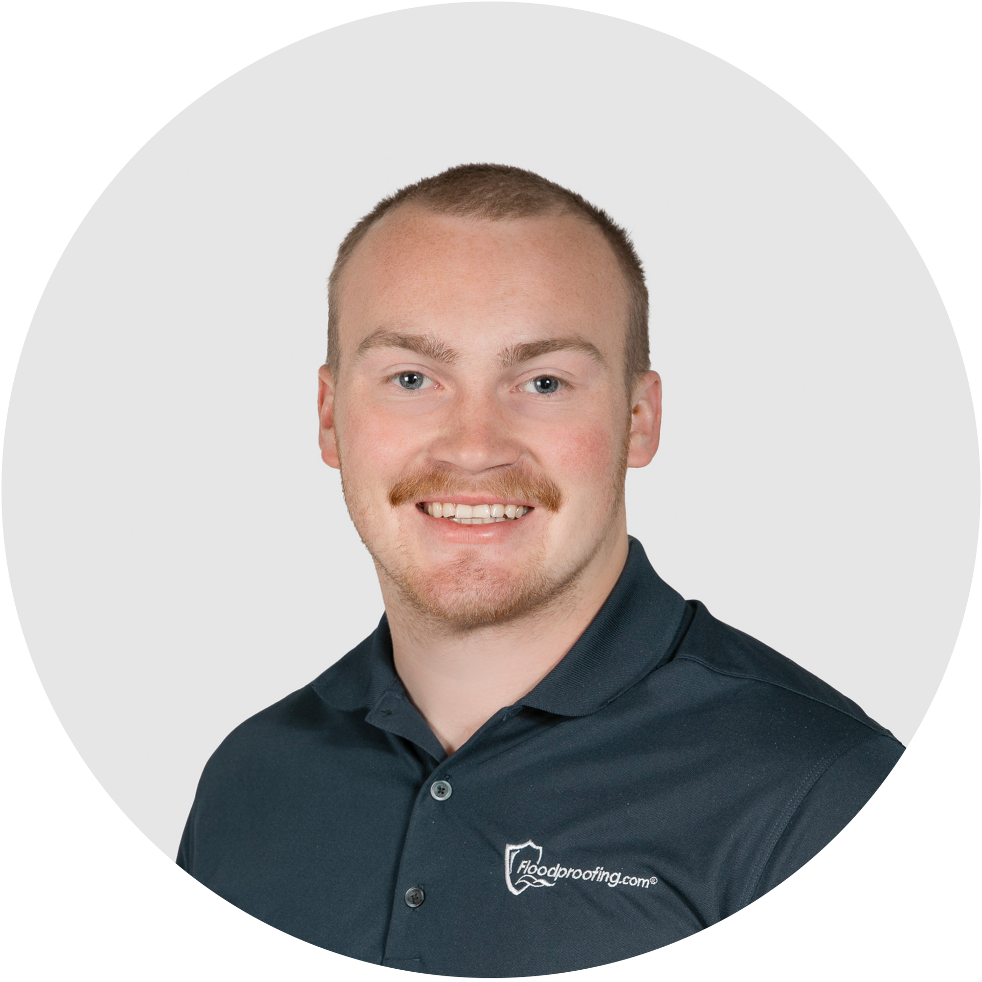 A man in a black polo shirt is smiling in a circle.