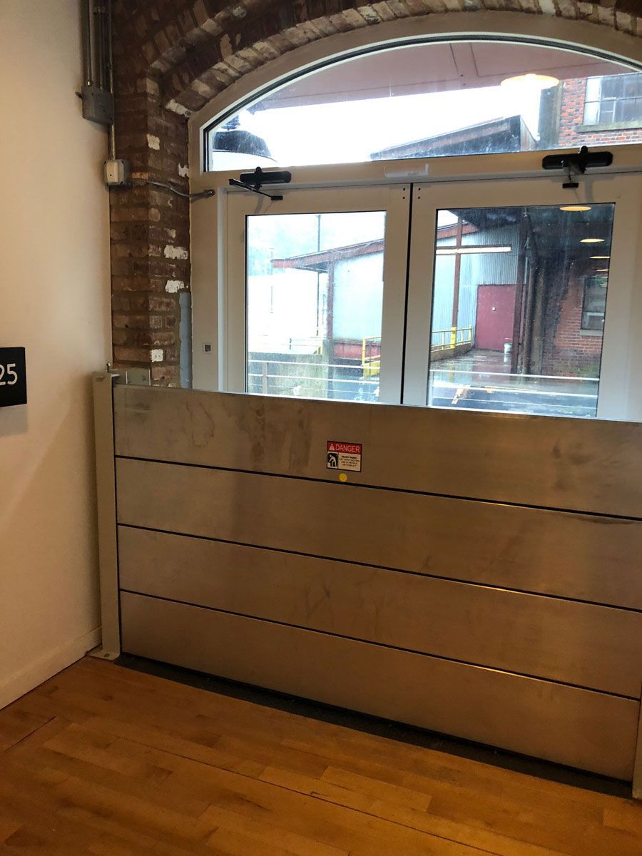 A flood barrier is in front of a window in a room