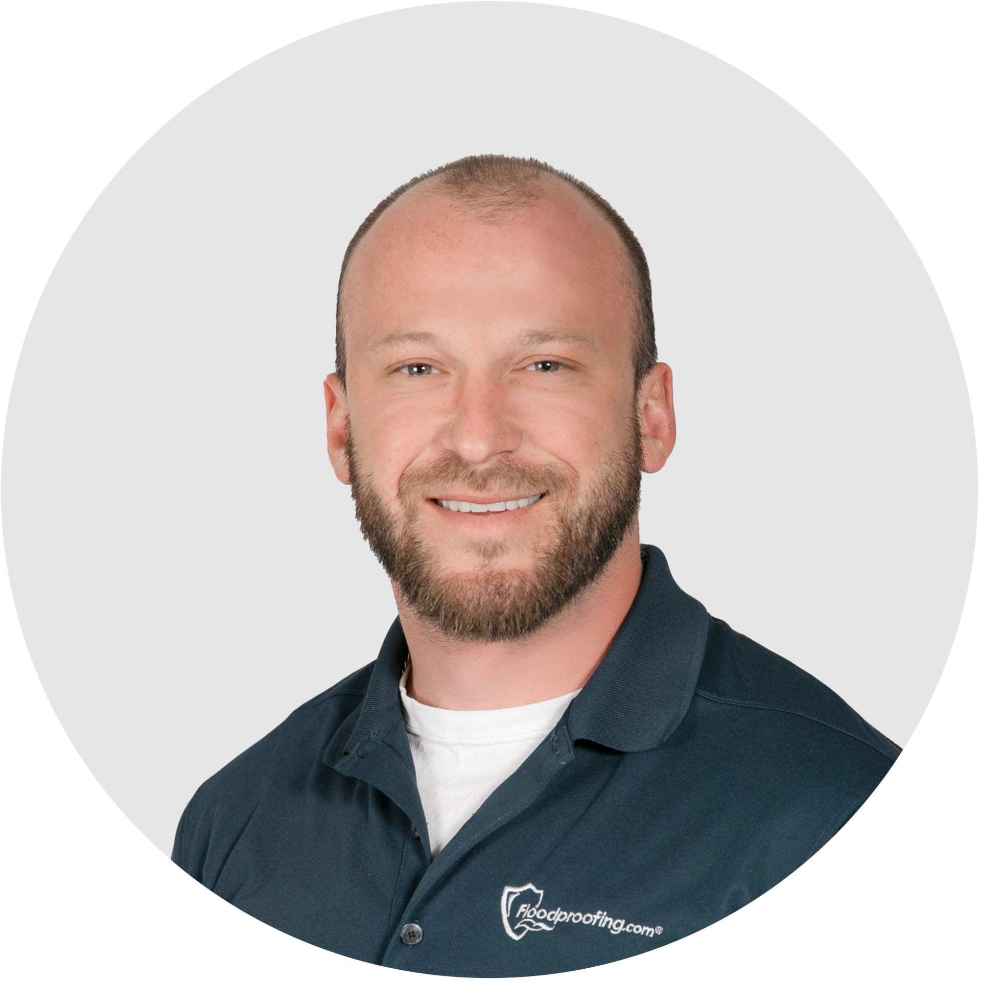 A bald man with a beard is smiling in a circle.