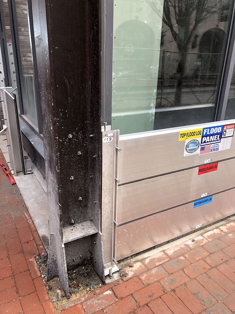 A flood barrier is sitting on the side of a building next to a window.