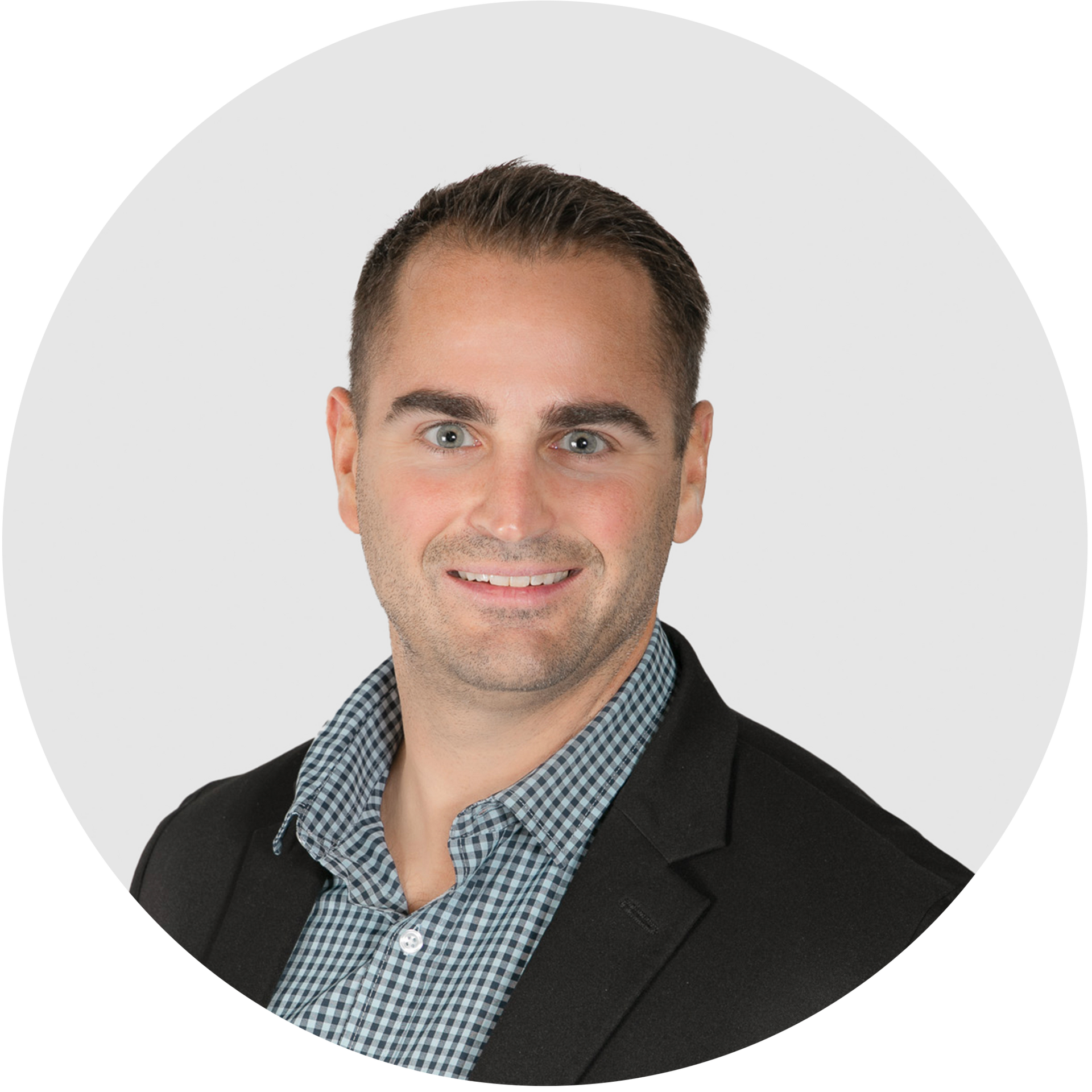 A man in a suit and plaid shirt is smiling in a circle.