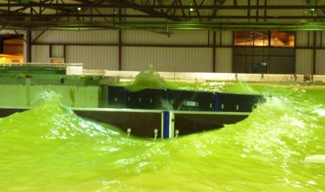 A large body of green liquid is floating in a large room.