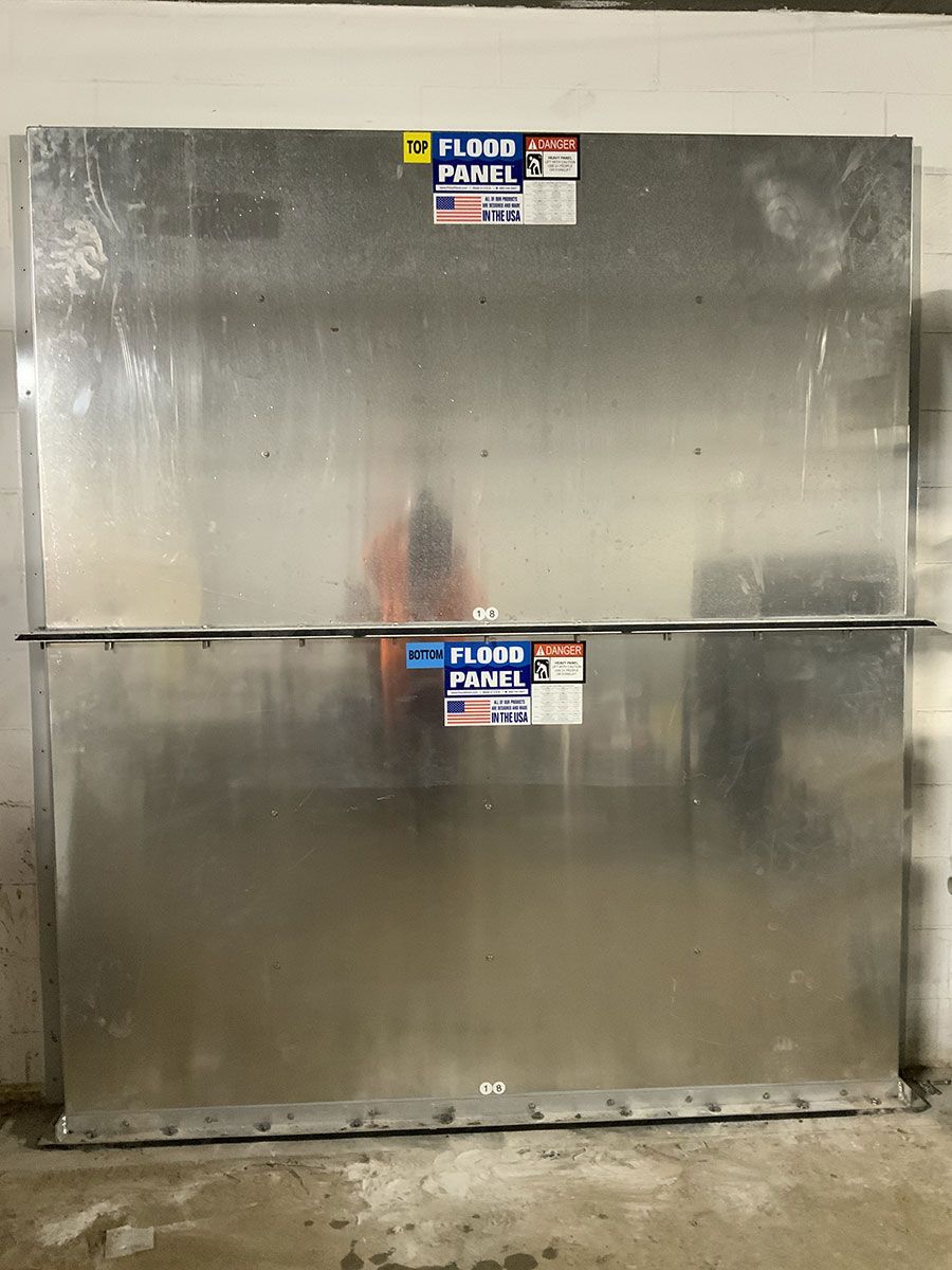 Two metal boxes are stacked on top of each other in a room.