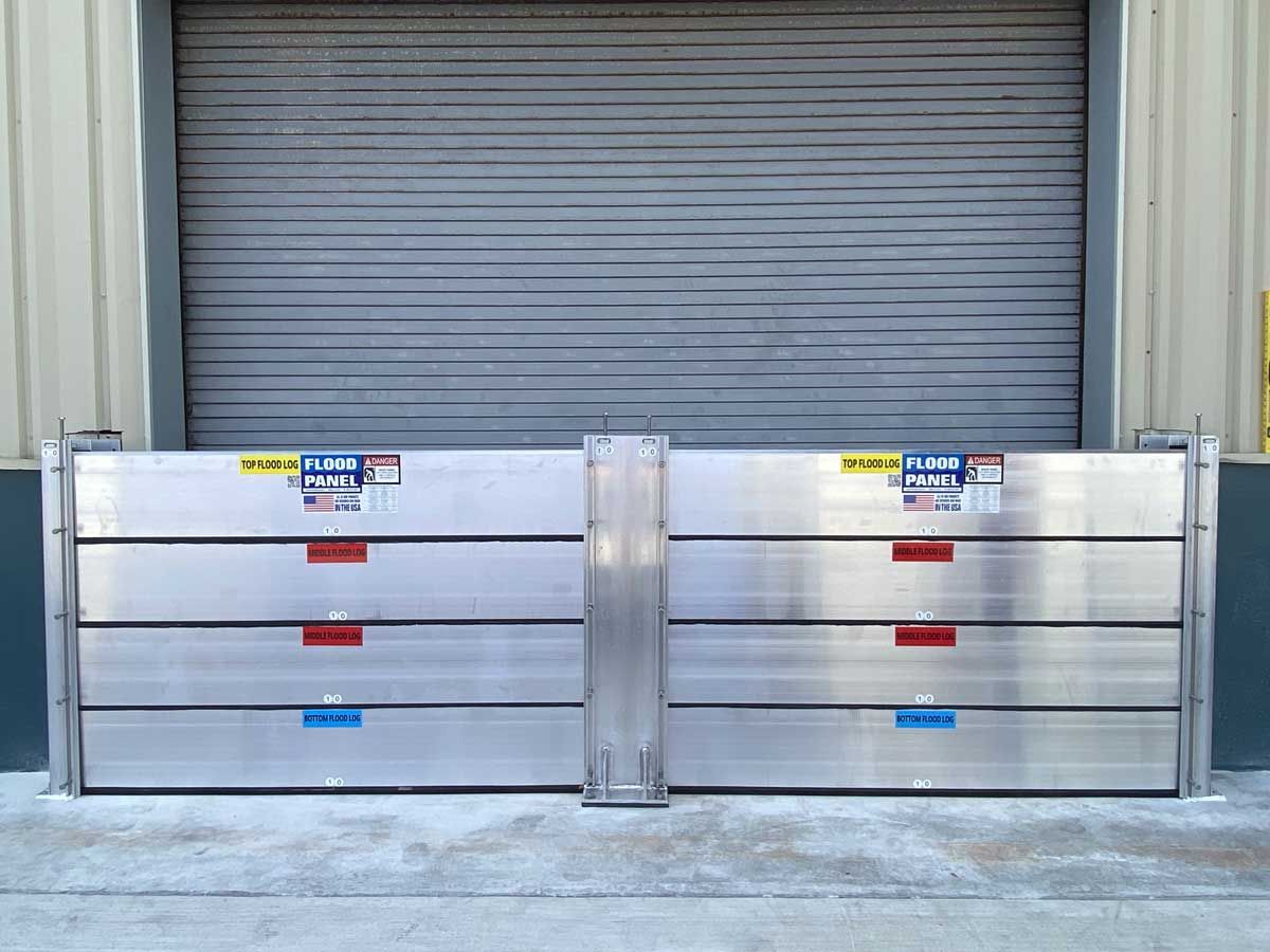 A gray garage door with a metal barrier in front of it