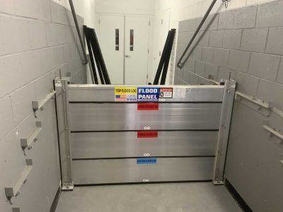 A flood panel is sitting in a hallway next to a door.