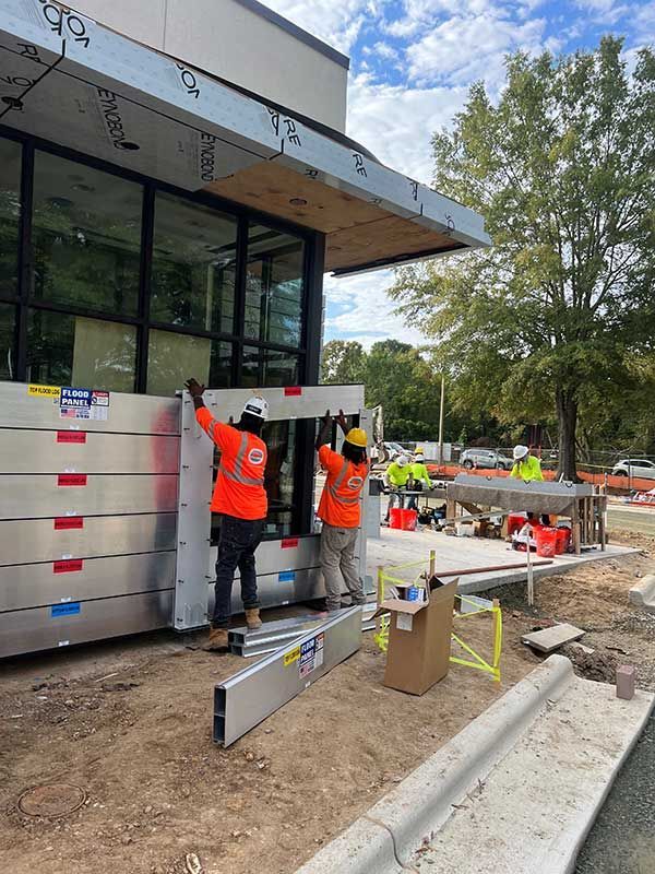 Two construction workers are working on a building under construction.