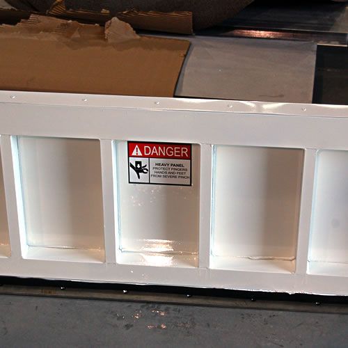 A white container with a danger sign on it
