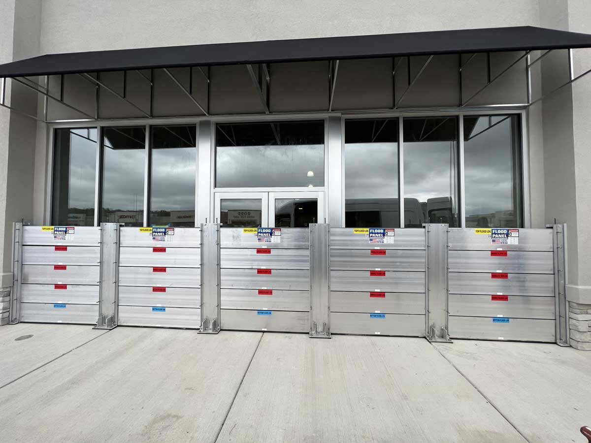 A building with a canopy and flood barriers in front of it