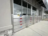 A row of aluminum flood barriers on the side of a building.
