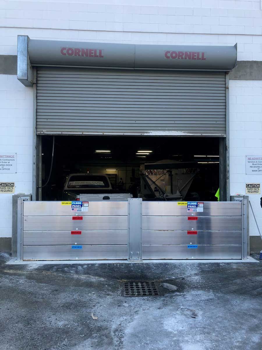 A garage door with a flood barrier in front of it.