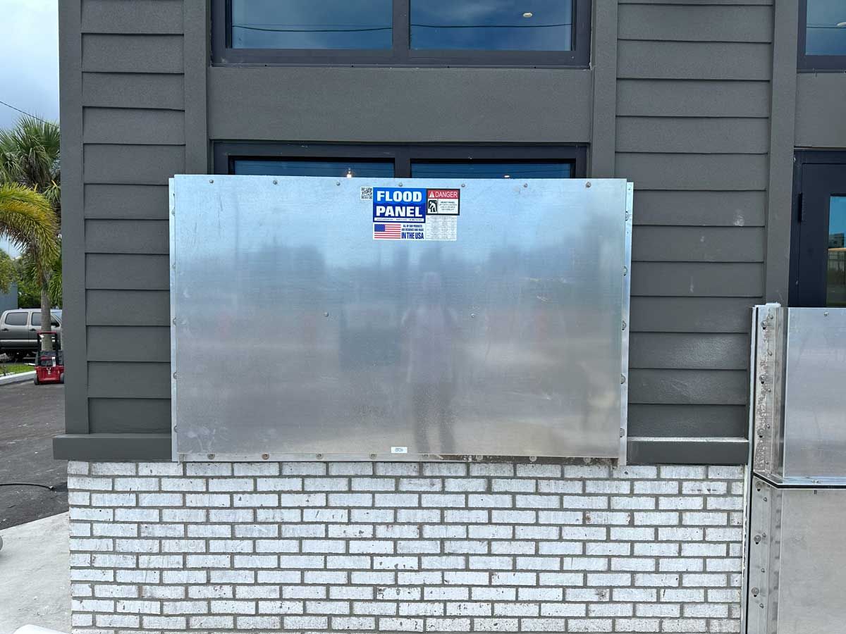 A brick wall with a stainless steel box on it