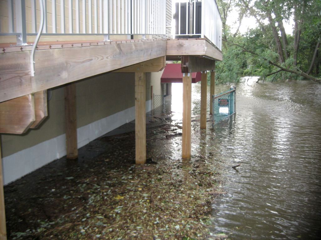 A flooded area with a house in the background