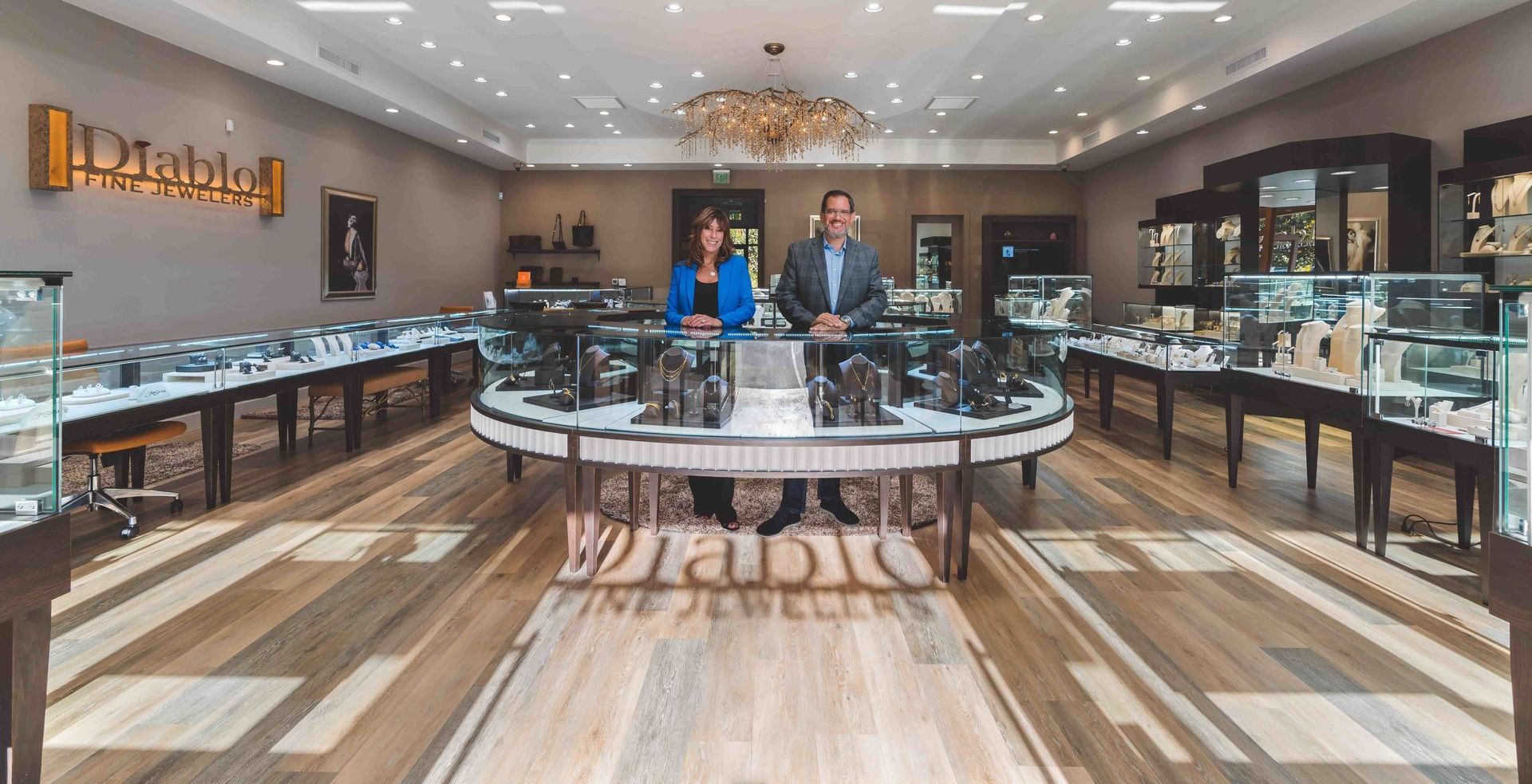 A man and a woman are standing in a jewelry store. A jewelry store interior
