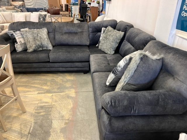 A large sectional couch is sitting in a living room.