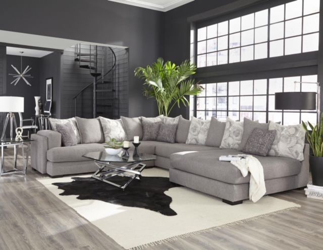A living room with a large sectional couch and a coffee table