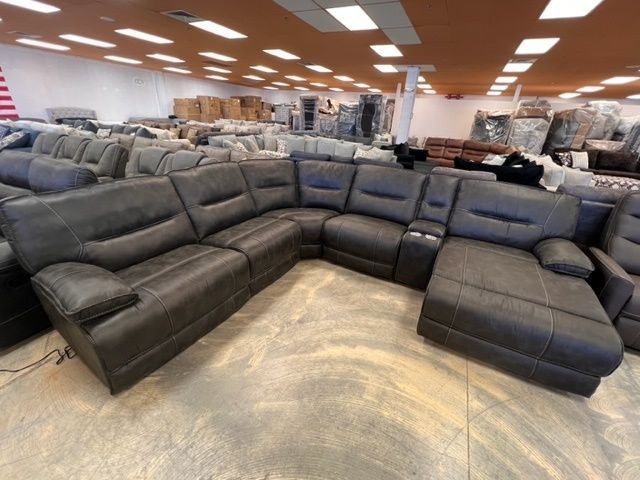 A large sectional couch is sitting in a store.