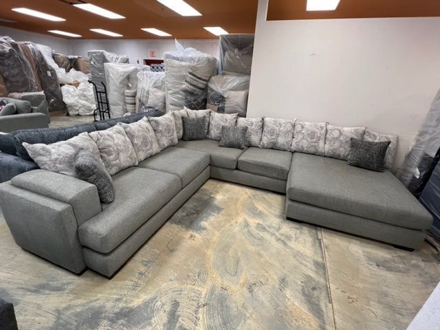 A large sectional couch is sitting in a room.