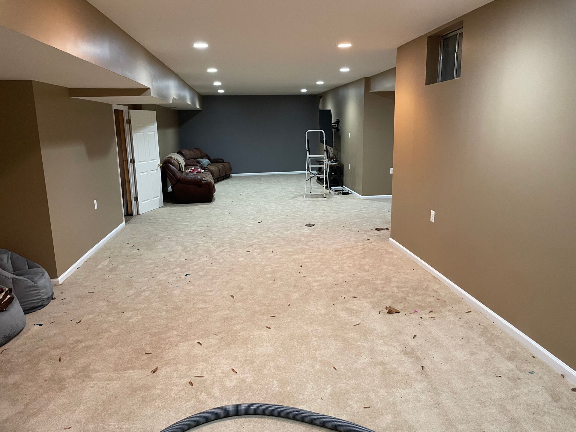 There is a vacuum hose in the middle of the room.