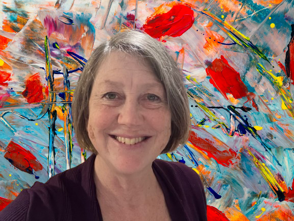 Woman smiling in front of a colorful, abstract painting with red, blue, and orange brushstrokes.