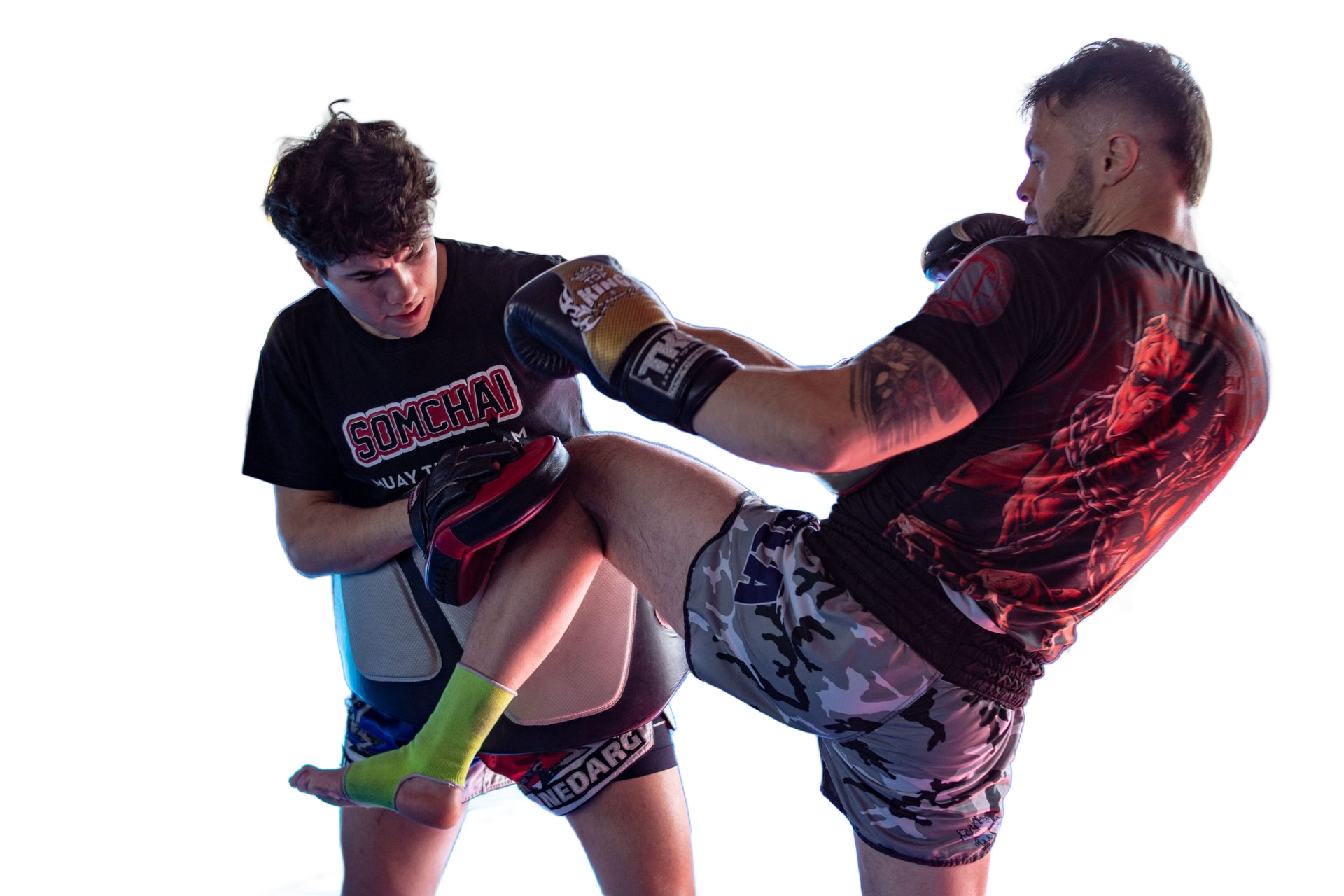 Two martial artists sparring, one delivering a high kick to the other against a white background