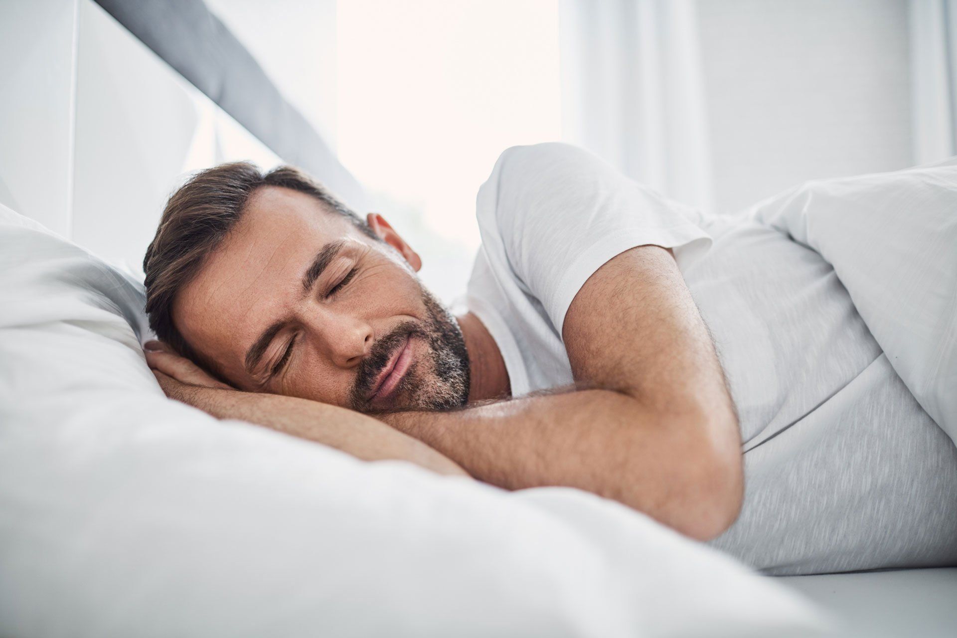 Guy Sleeping on his bed