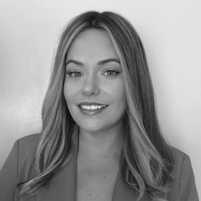 Portrait of a smiling blonde woman against a plain background