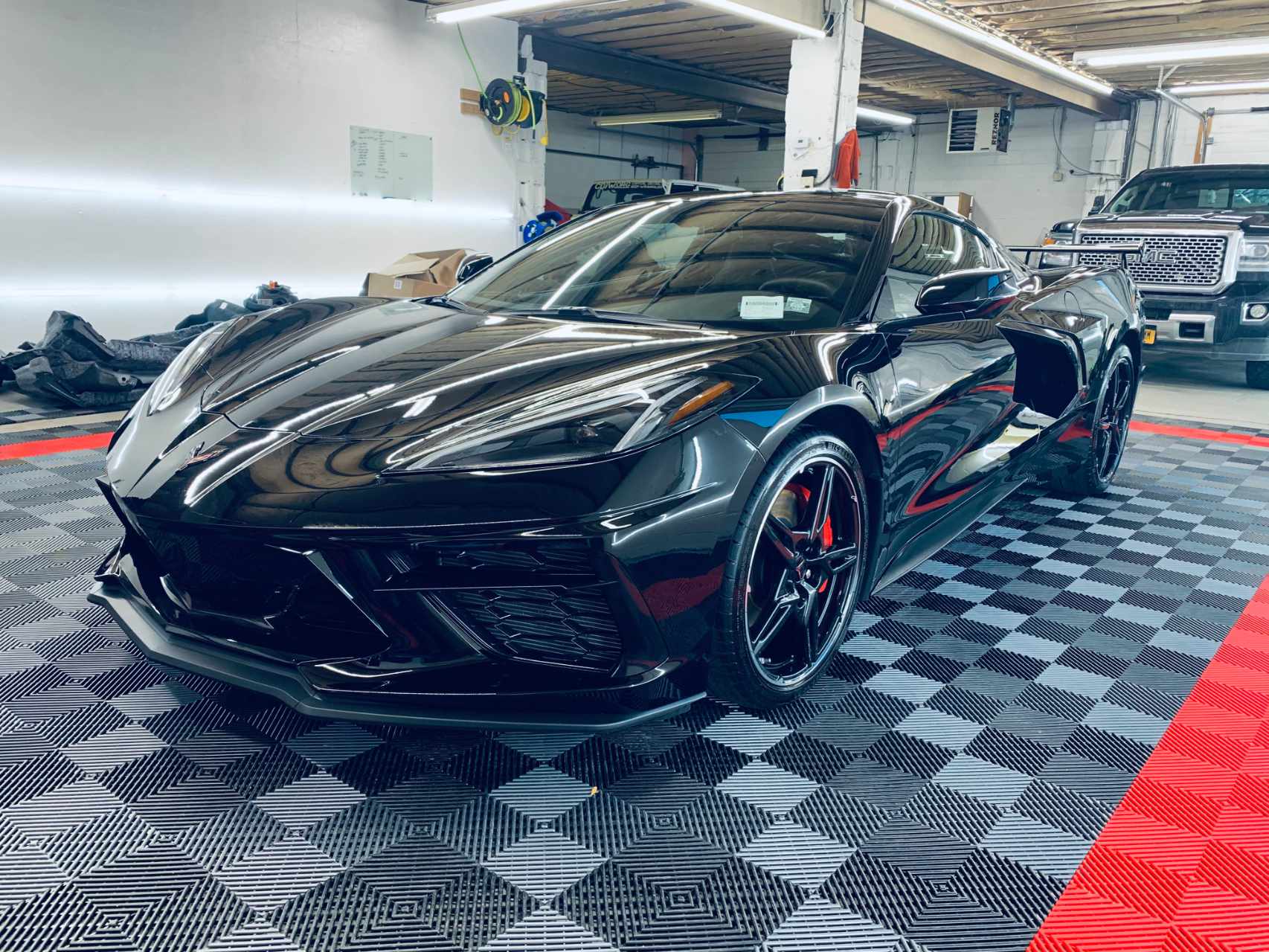 shiny black corvette at mirror image protective coatings facility