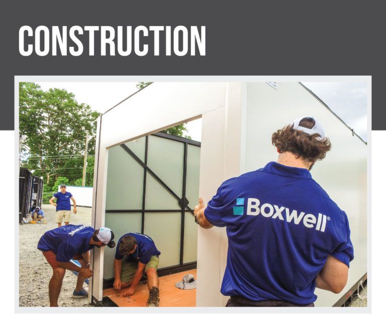 a man wearing a blue shirt that says boxwell on it