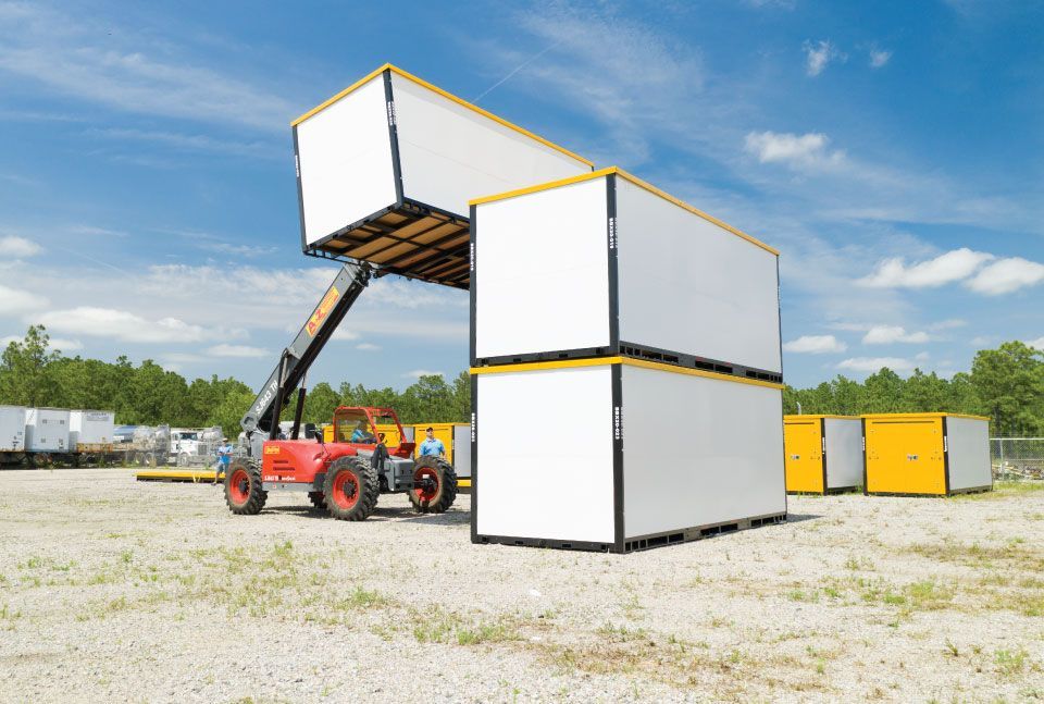 a red forklift is lifting a stack of containers with a sign on the side that says ' container '