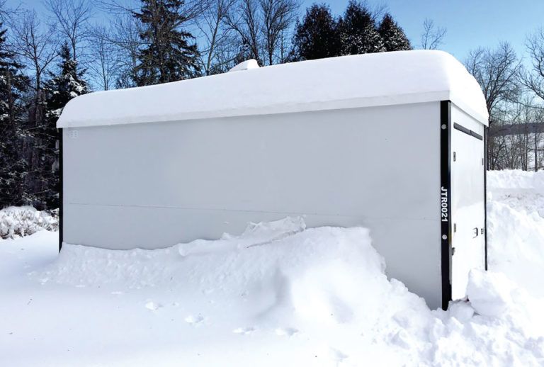 a snow covered building with jtr024 on the side