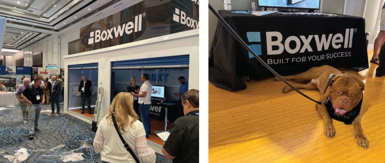 a group of people are standing in front of a boxwell booth .
