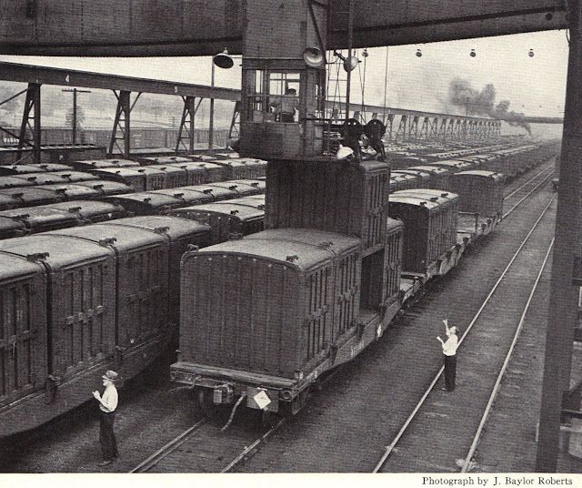 a black and white photo of a train yard by j. baylor roberts