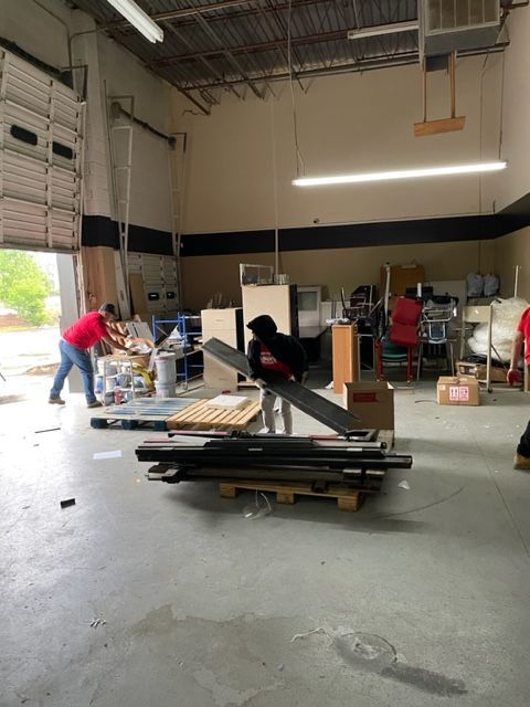 A group of people are working in a warehouse