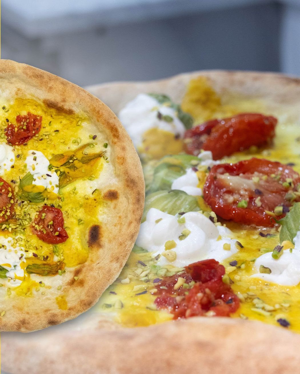 Primo piano di una focaccia con salsa gialla cremosa, pomodorini, erbe aromatiche e fiocchi di formaggio bianco.