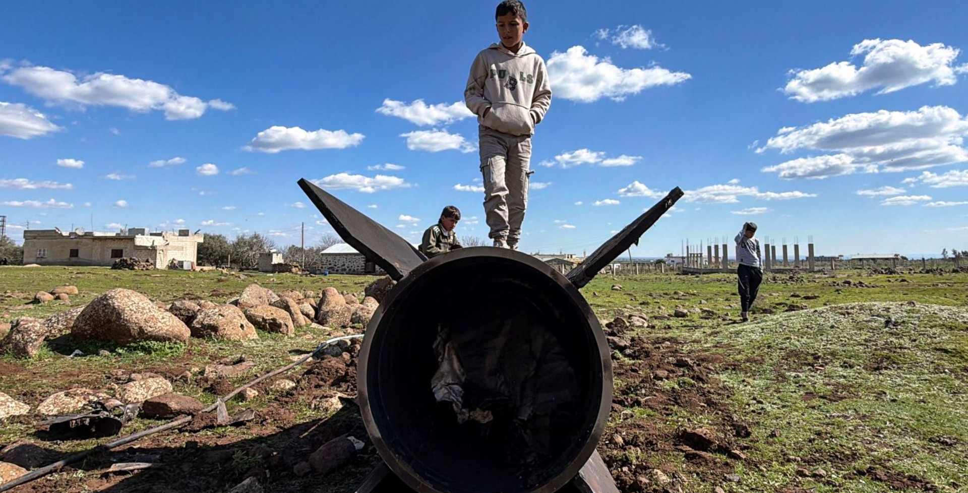 Unknown child playing on an unknown non-exploded missile in the MIddle East.  