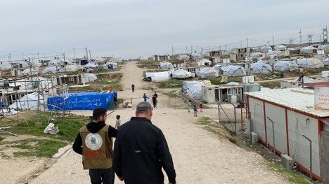 Michael Parks walking through village in Middle East