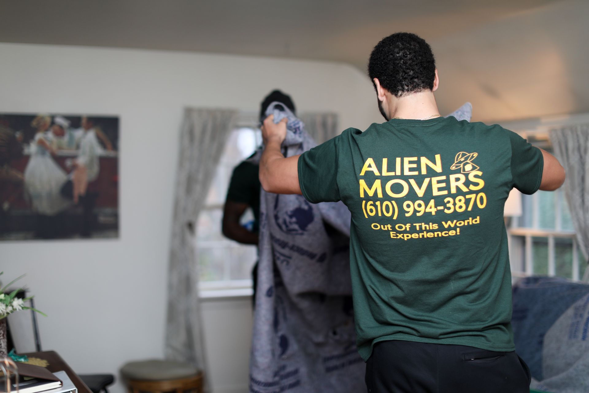 An Alien Movers employee in orange loads furniture with care into a moving van in Philadelphia.