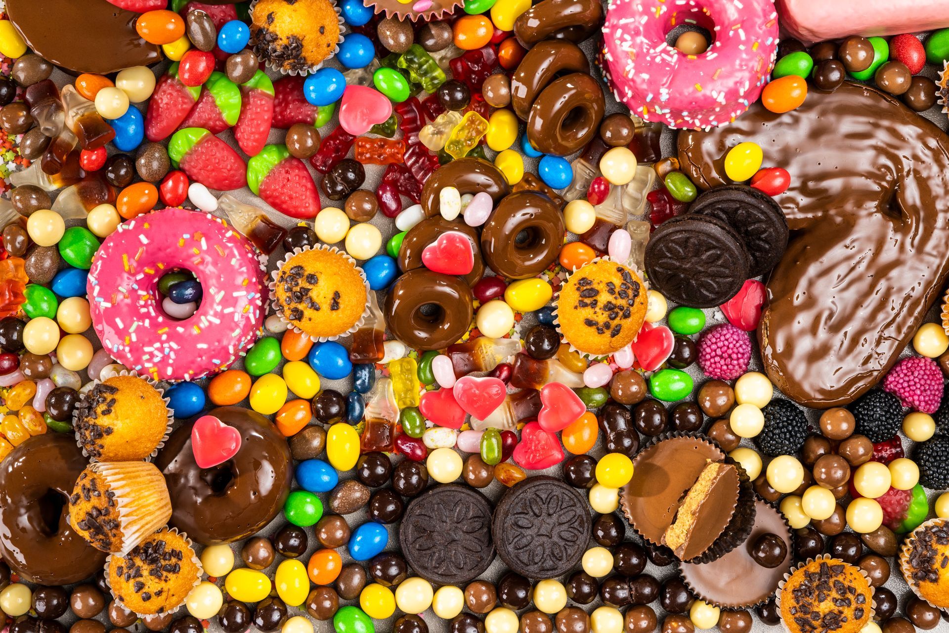 There are many different types of candy on the table.