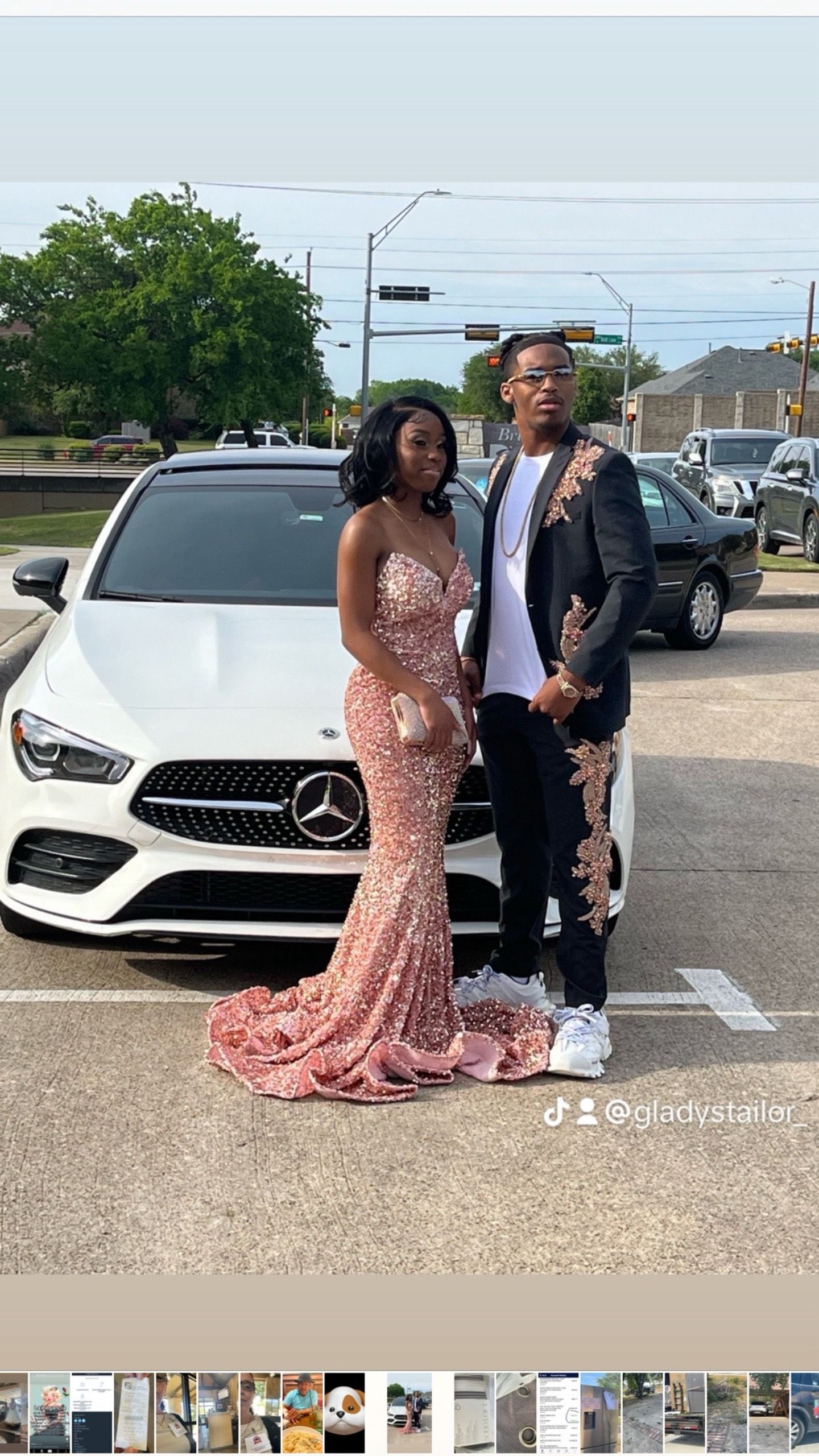 A man and a woman are standing in front of a white mercedes benz.