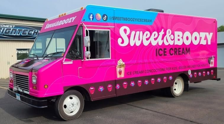 Bright pink Sweet & Boozy ice cream truck parked outdoors on a street